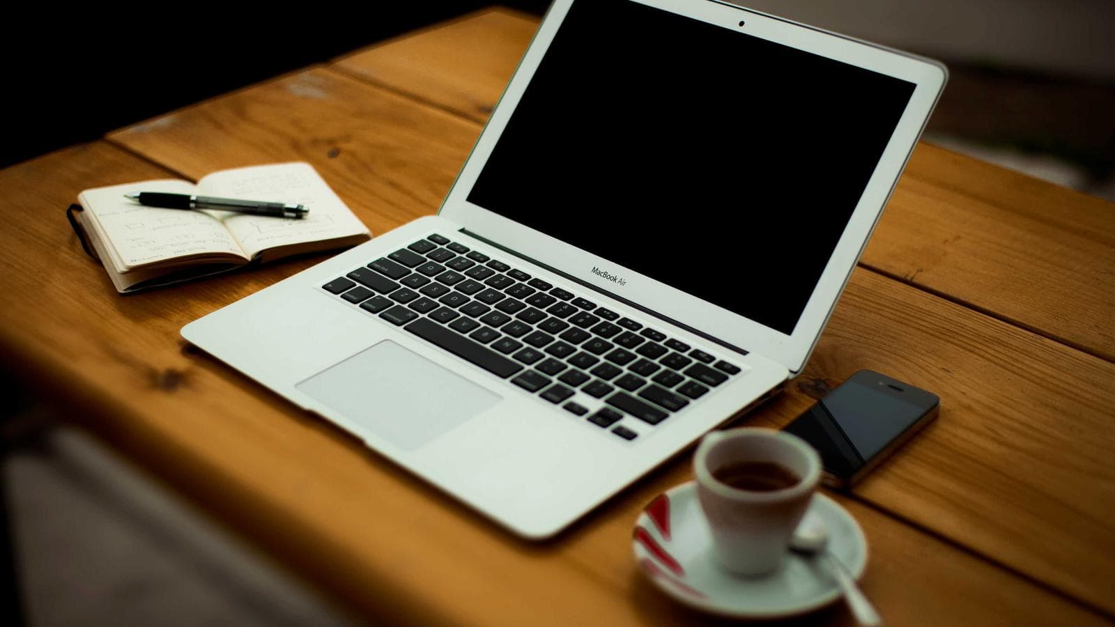A laptop open on a cafe table